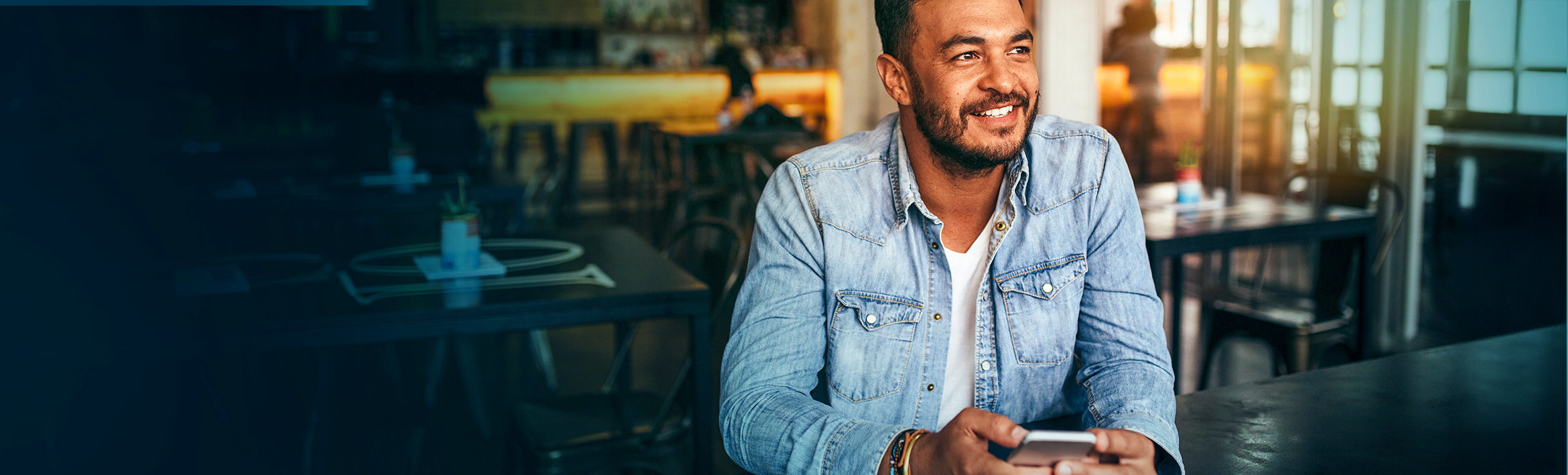 Toddler holding a teddy bear and smiling